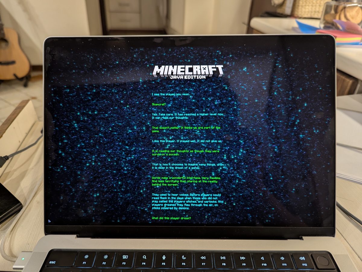 A laptop showing the Minecraft end poem on a starry screen